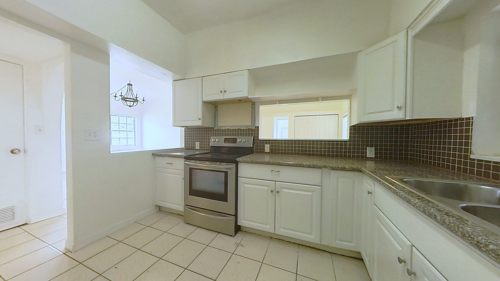 Kitchen with granite counters and white cabinetry