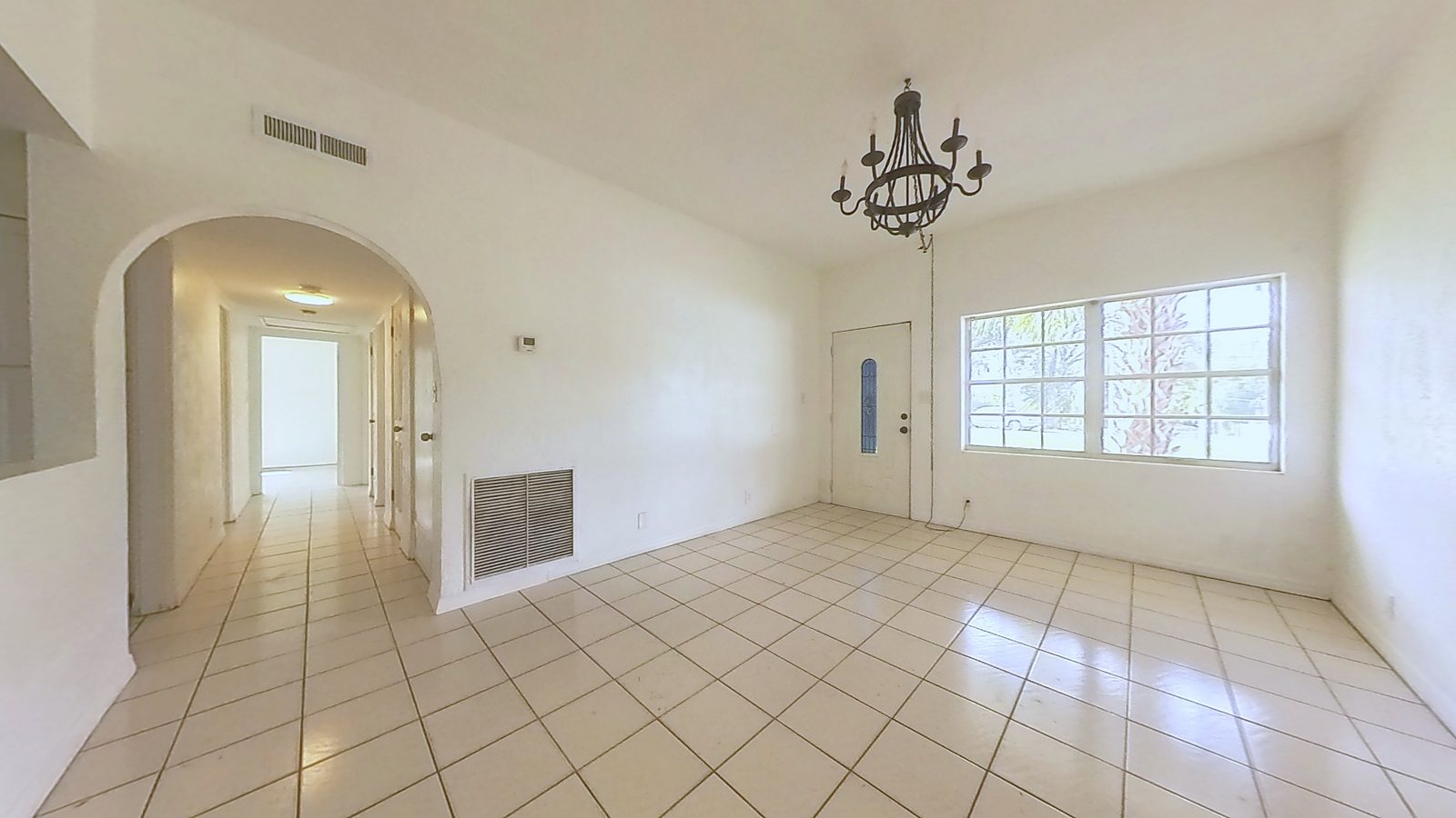 Living room at 120 Kay Lane, tile floors and arched opening